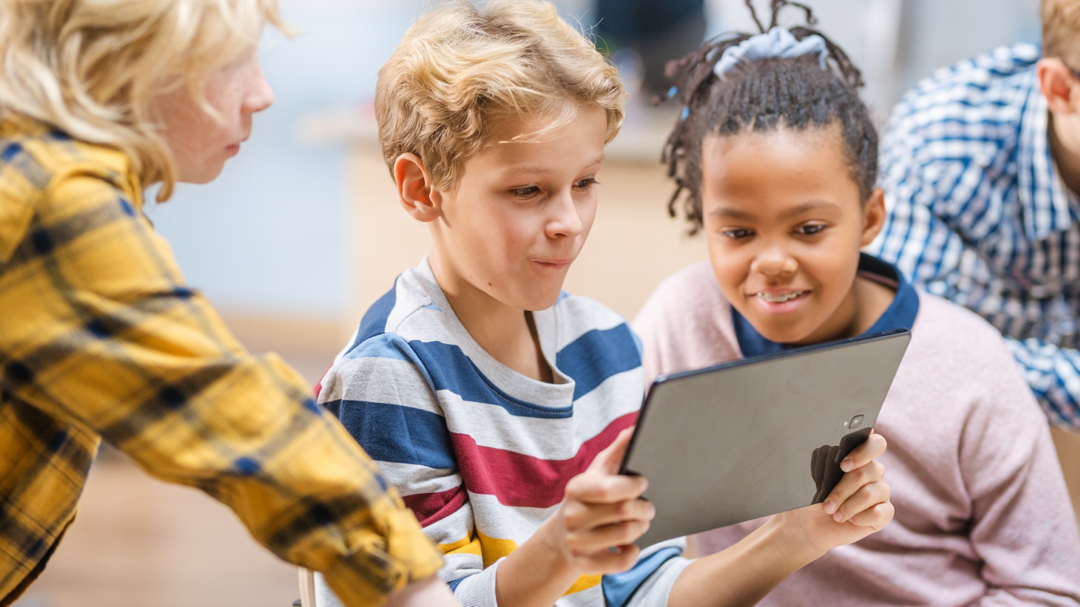 Elementary School Computer Science Class: Children Use Digital Tablet Computers and Smartphones with Augmented Reality Software, They’re Excited, Full of Wonder. Children in STEM, Playing and Learning